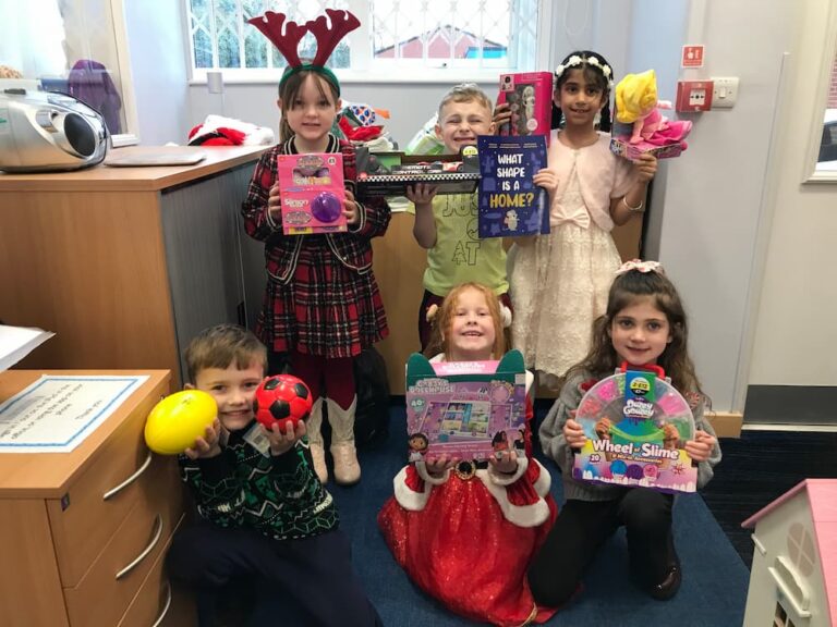 Children holding out presents collected to donate to the Mission Christmas appeal